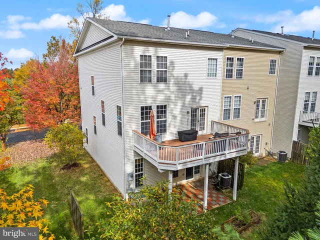 a view of a deck with two chairs and wooden floor
