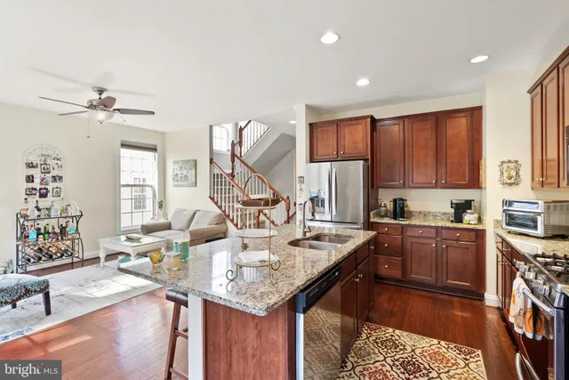 a kitchen with stainless steel appliances granite countertop a sink stove and cabinets