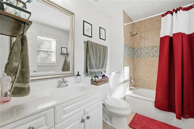 a bedroom with furniture and a flat screen tv