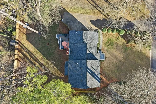 a wooden bench sitting in front of a house