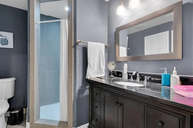 a bathroom with a sink vanity and mirror