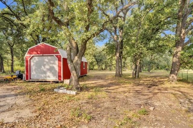 a backyard of a house with table and chairs