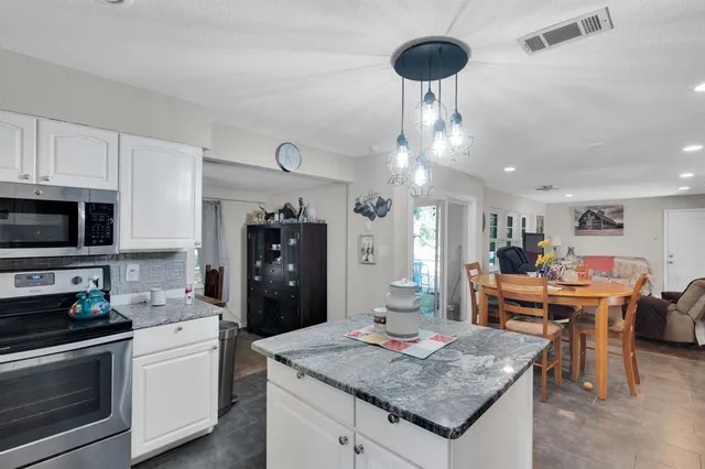 a view of yard with tree in front of it