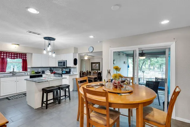 a view of a a dining room with furniture window and wooden floor