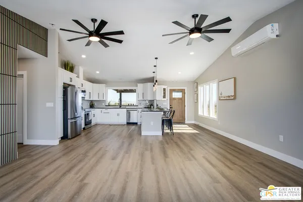 a view of kitchen with wooden floor and a ceiling fan