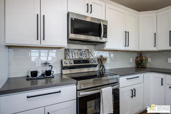 a bathroom with a glass shower door and a sink