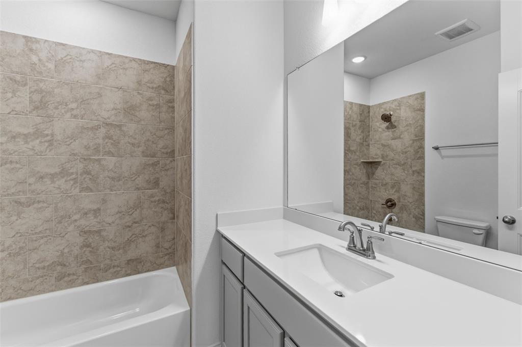 144 Oak Grv Way Springtown, TX 76082 - Photo 17 of 27 a bathroom with a bathtub sink vanity and a mirror