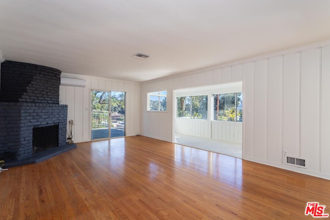 3936 Roderick Road Los Angeles, CA 90065 - Photo 8 of 36 a view of an empty room with wooden floor and a window