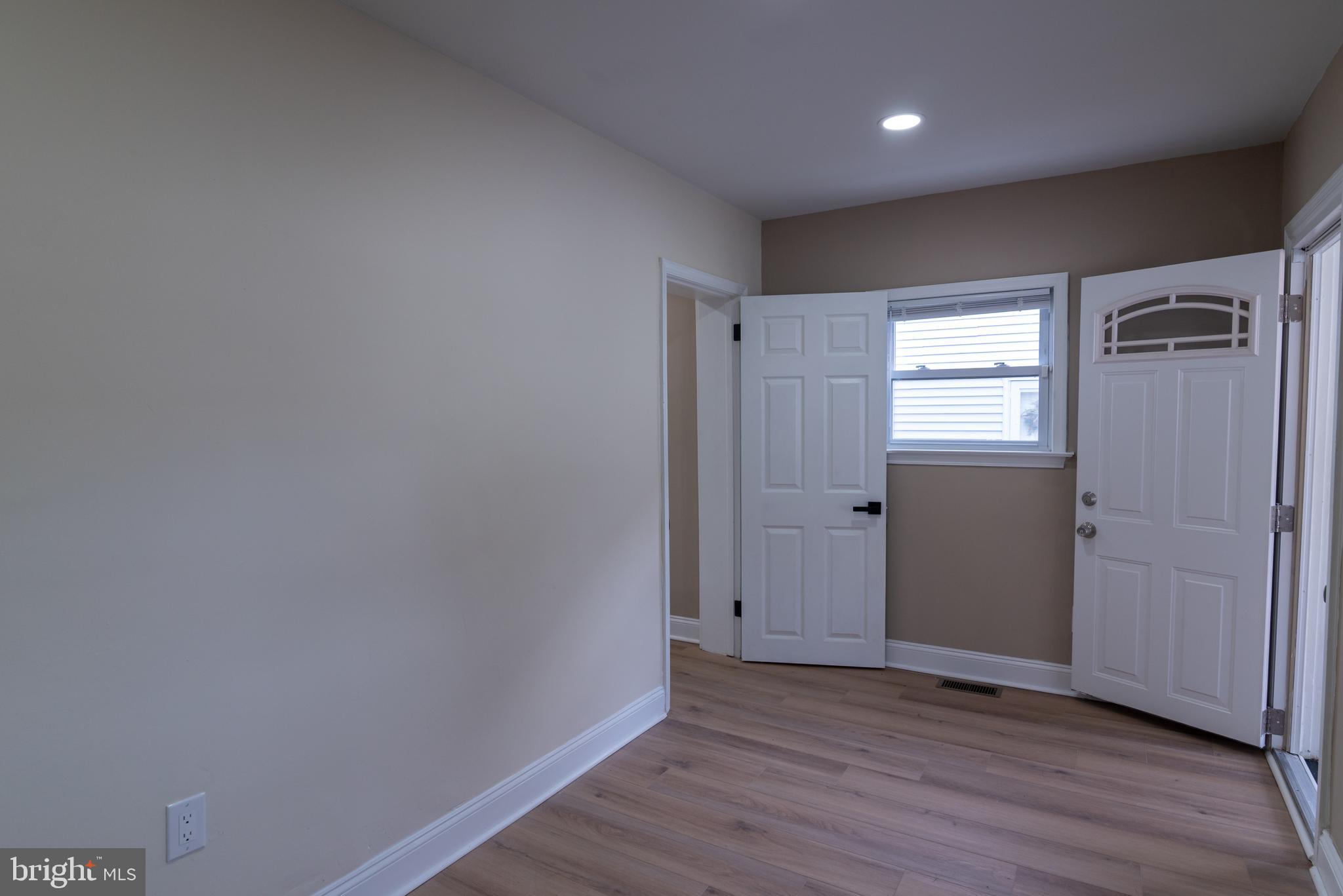 8030 Ferndale Street Philadelphia, PA 19111 - Photo 13 of 36 a view of an empty room with wooden floor and a window