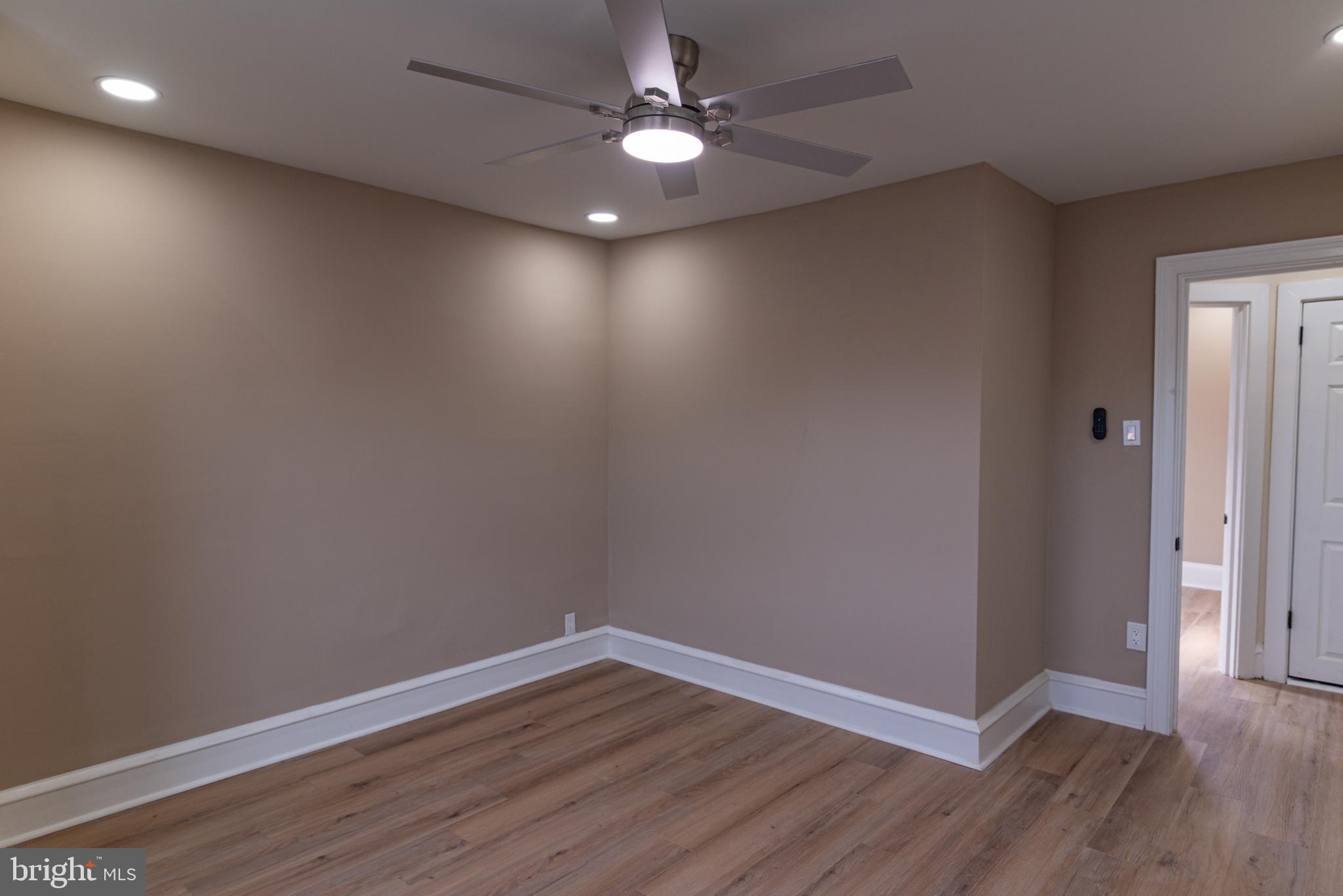 8030 Ferndale Street Philadelphia, PA 19111 - Photo 15 of 36 an empty room with wooden floor and fan