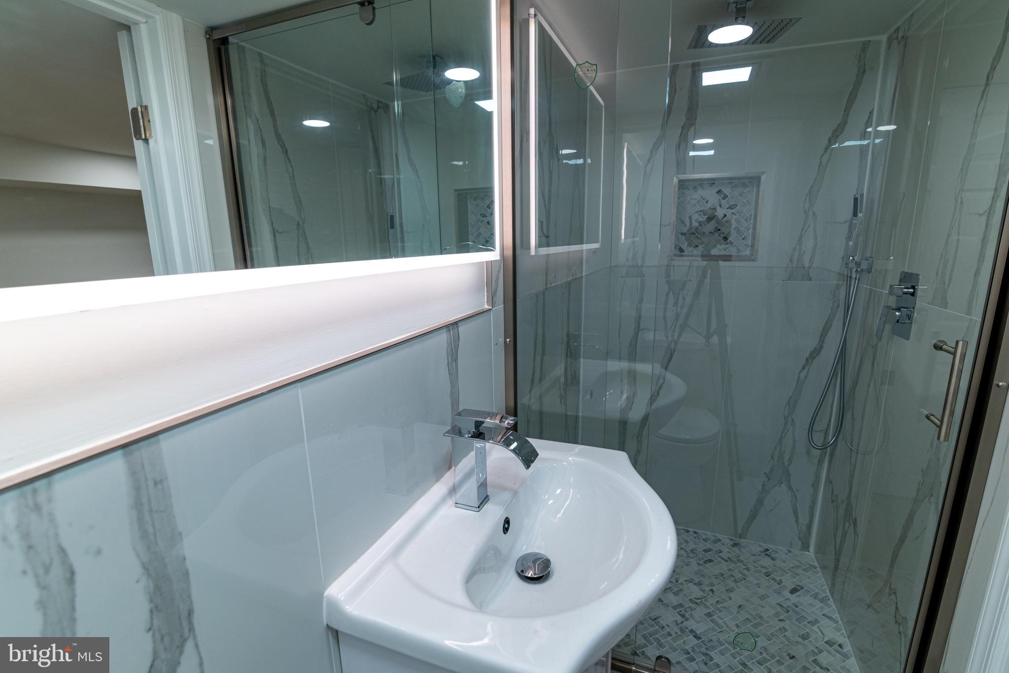 8030 Ferndale Street Philadelphia, PA 19111 - Photo 21 of 36 a bathroom with a sink and mirror