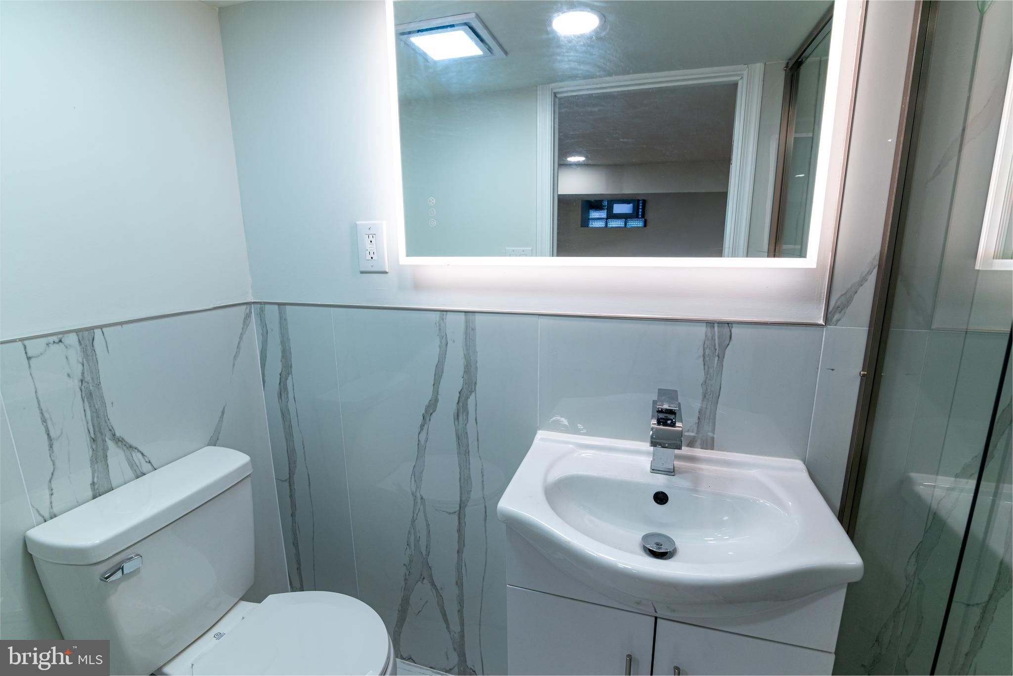 8030 Ferndale Street Philadelphia, PA 19111 - Photo 22 of 36 a bathroom with a sink mirror and toilet