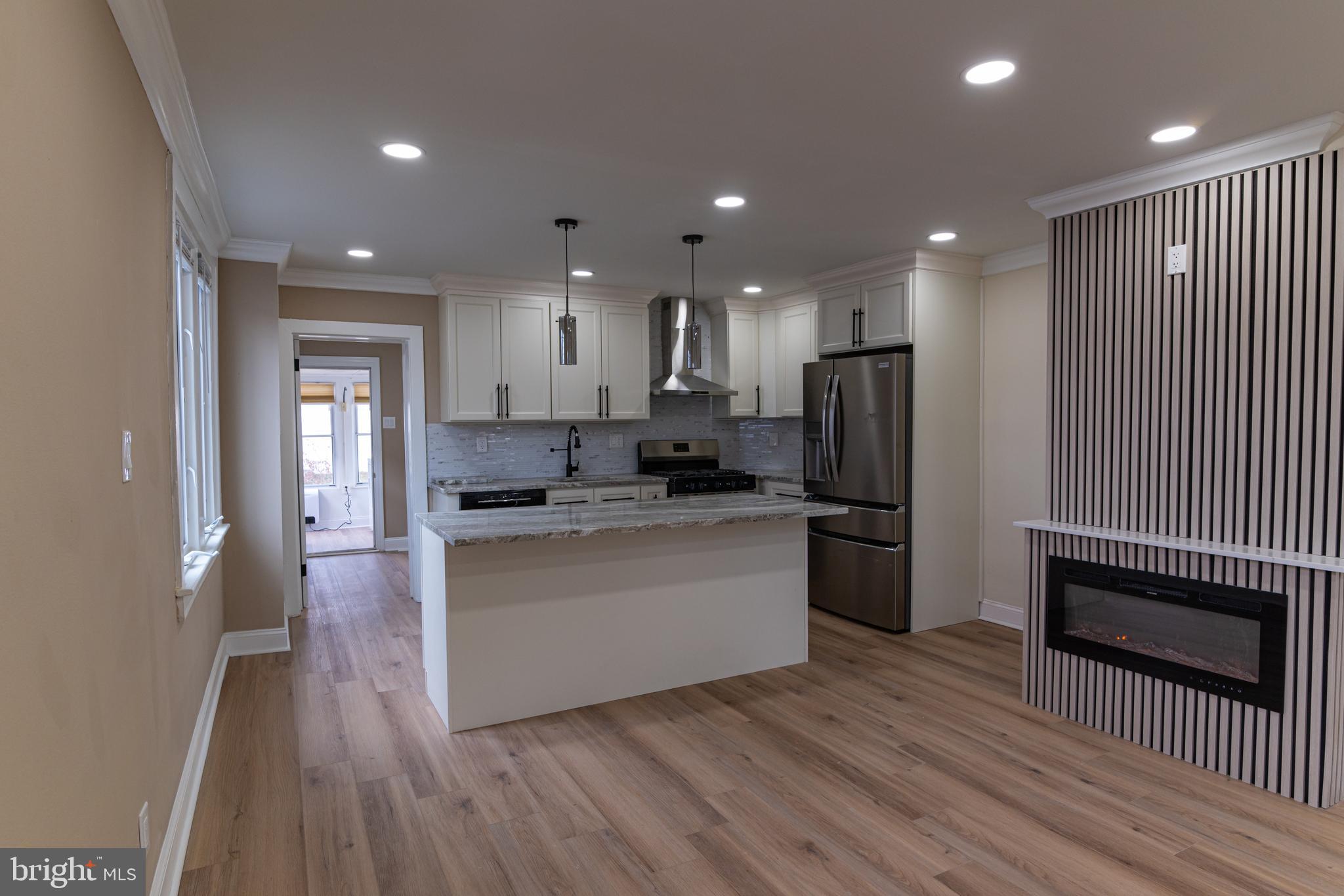 8030 Ferndale Street Philadelphia, PA 19111 - Photo 8 of 36 a kitchen with stainless steel appliances granite countertop a refrigerator a sink a stove and oven a wooden floors