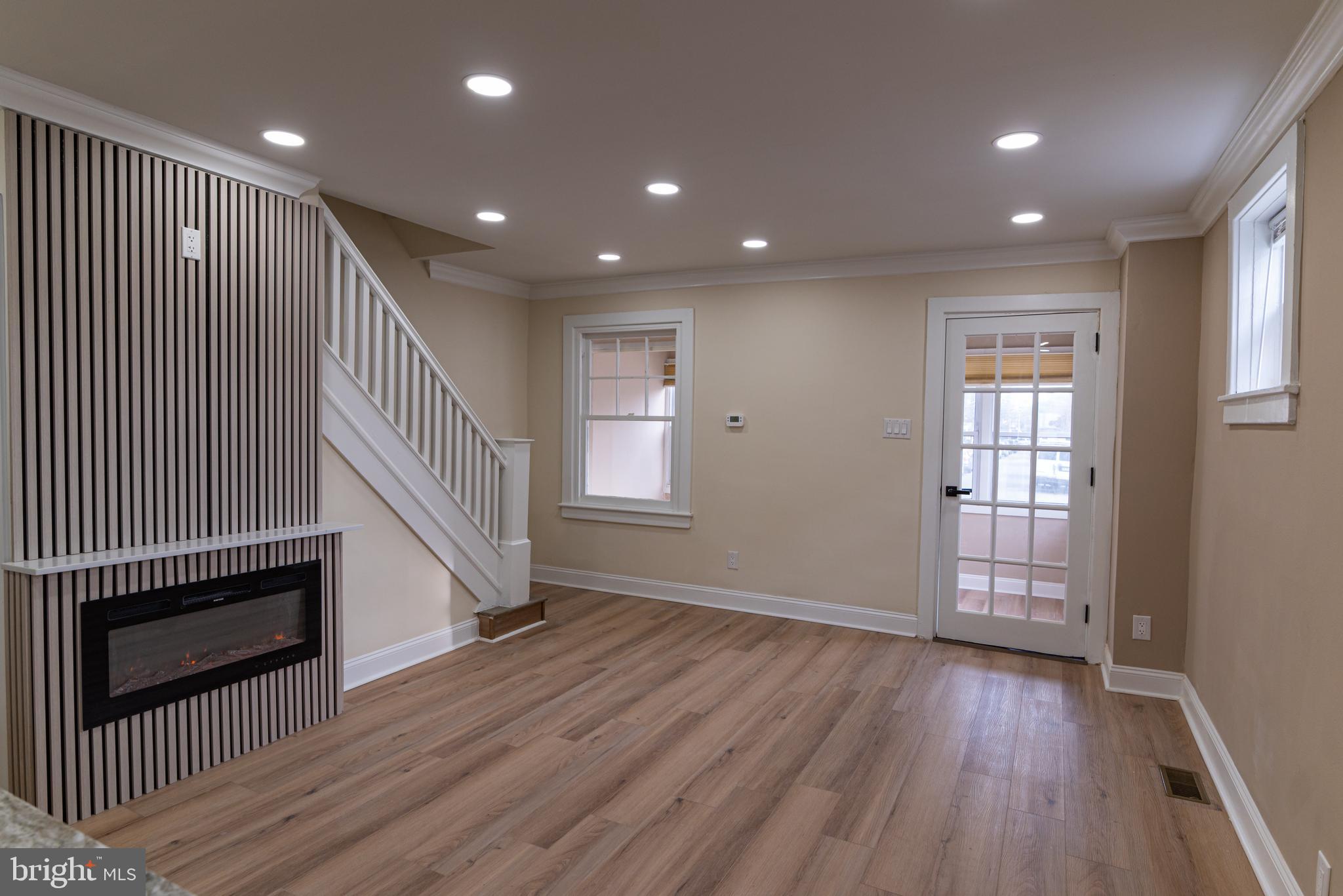 8030 Ferndale Street Philadelphia, PA 19111 - Photo 9 of 36 an entryway of a house with wooden floor stairs and windows