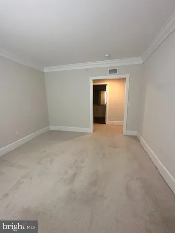 a view of an empty room and a window