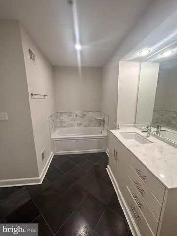 a bathroom with a sink a toilet a and mirror