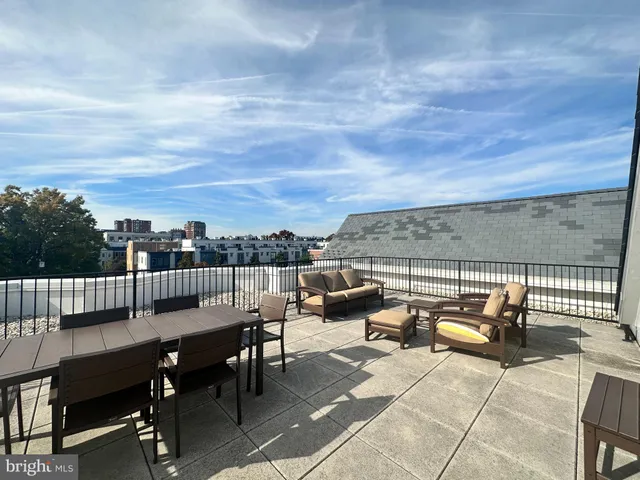 a terrace with outdoor seating and city view