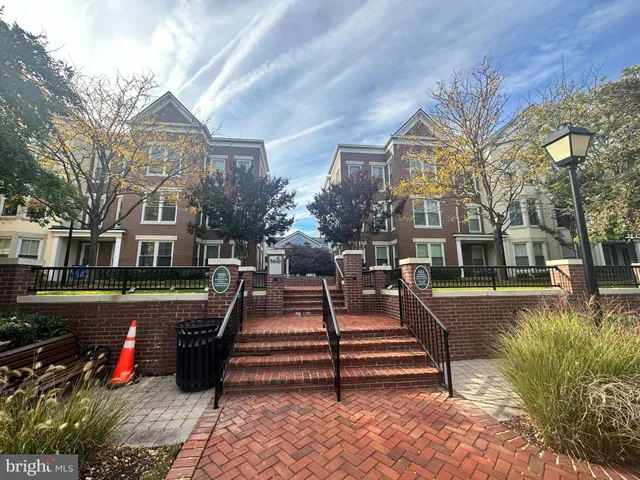 a view of a building with garden and a bench
