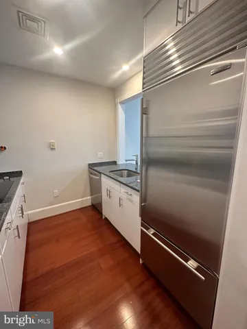 a kitchen with granite countertop a refrigerator and a stove
