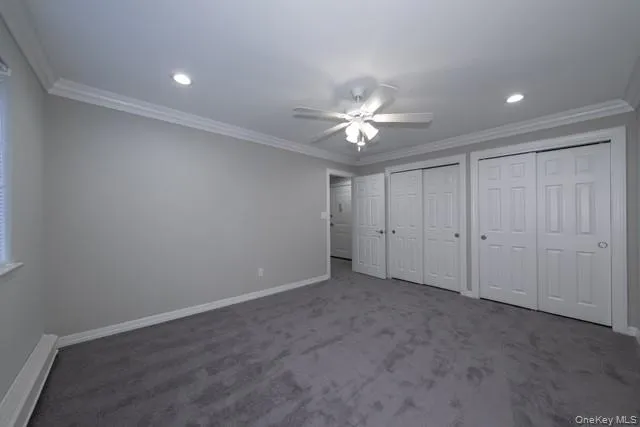 an empty room with a ceiling fan and a window