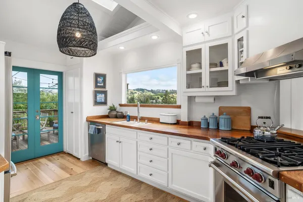 a kitchen with stainless steel appliances granite countertop a stove and a sink