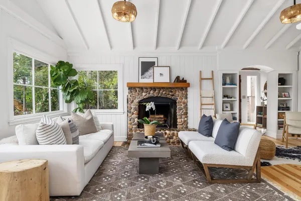 a living room with furniture and a fireplace
