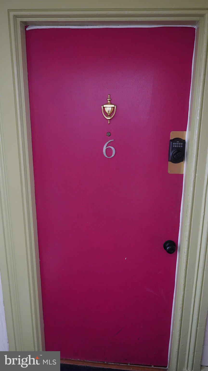 917 North Calvert Street, Unit 6 Baltimore, MD 21202 - Photo 3 of 10 Vibrant pink door with a golden touch.