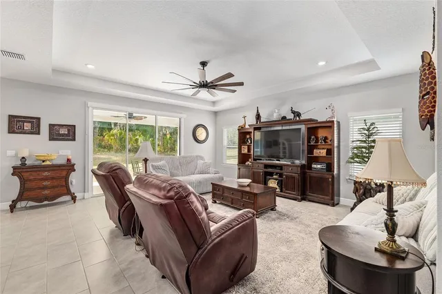 a living room with furniture kitchen view and a window