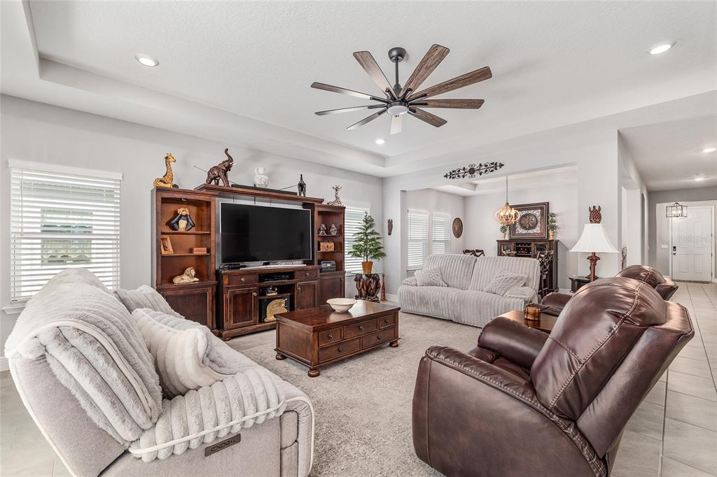 5912 Southwest 46th Drive Gainesville, FL 32608 - Photo 15 of 74 a living room with furniture a ceiling fan and a flat screen tv