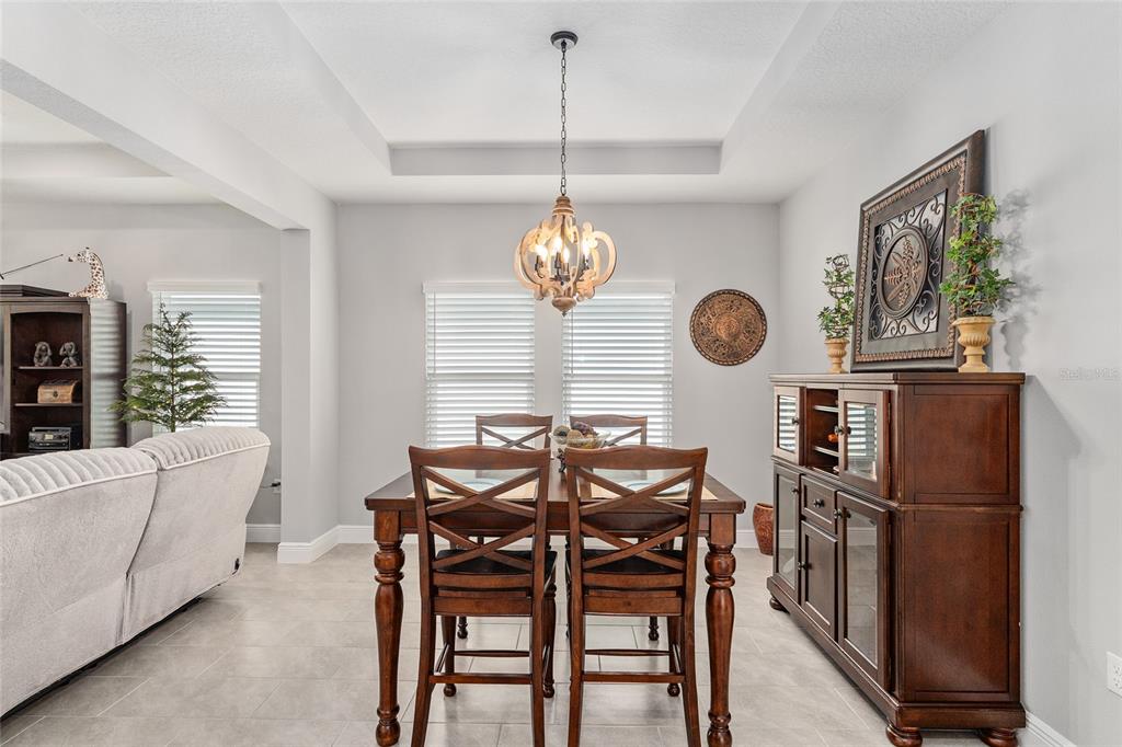 5912 Southwest 46th Drive Gainesville, FL 32608 - Photo 19 of 74 a view of a dining room with furniture window and wooden floor