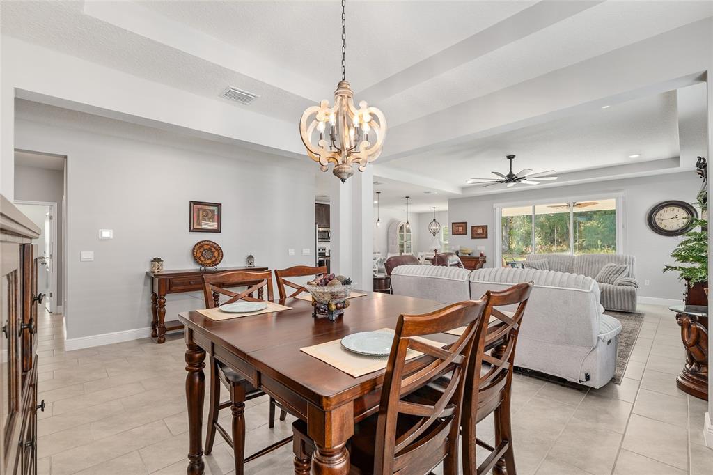 5912 Southwest 46th Drive Gainesville, FL 32608 - Photo 21 of 74 a view of a dining room with furniture and a chandelier