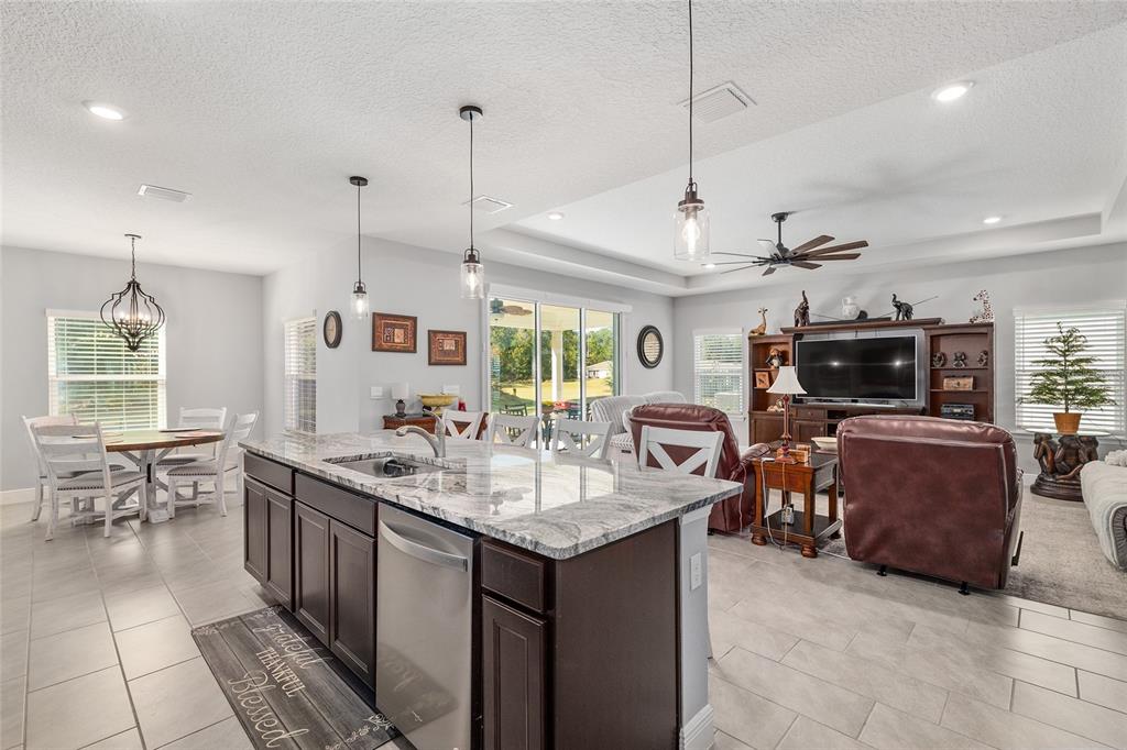 5912 Southwest 46th Drive Gainesville, FL 32608 - Photo 27 of 74 a kitchen with sink cabinets and living room view