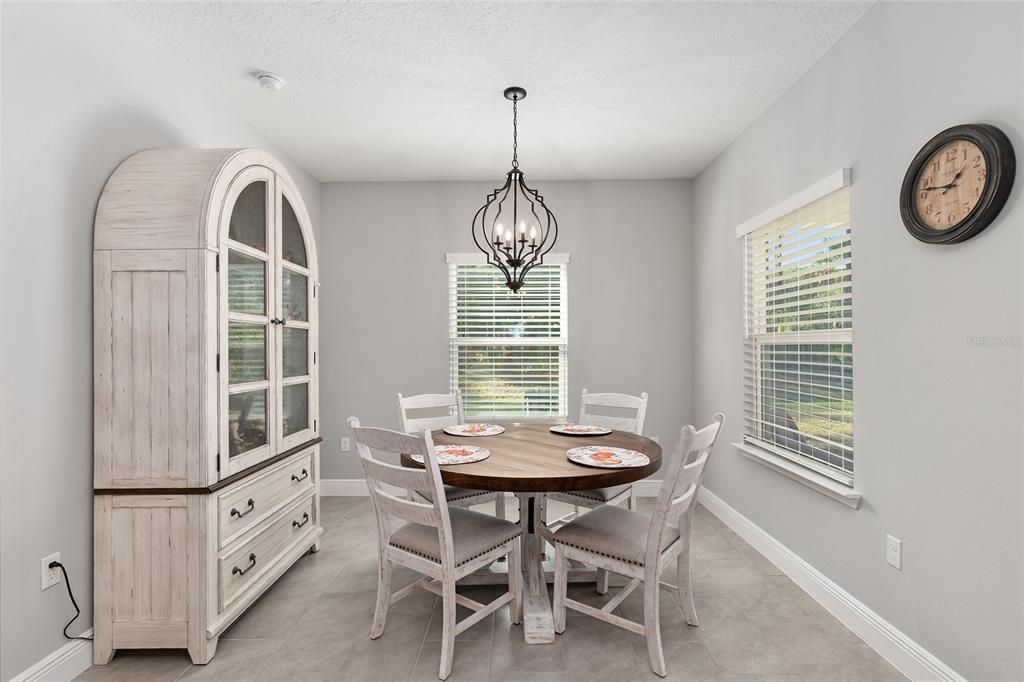 5912 Southwest 46th Drive Gainesville, FL 32608 - Photo 30 of 74 a view of a dining room with furniture window and wooden floor