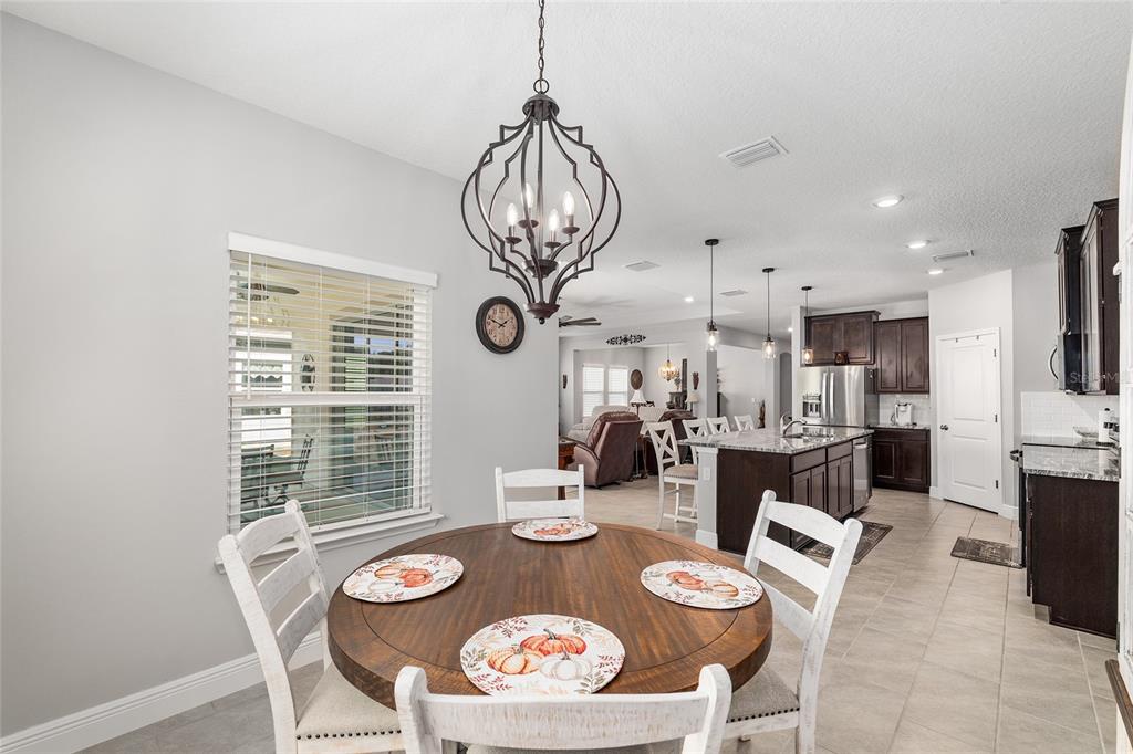5912 Southwest 46th Drive Gainesville, FL 32608 - Photo 32 of 74 a view of a dining room with furniture large window and wooden floor