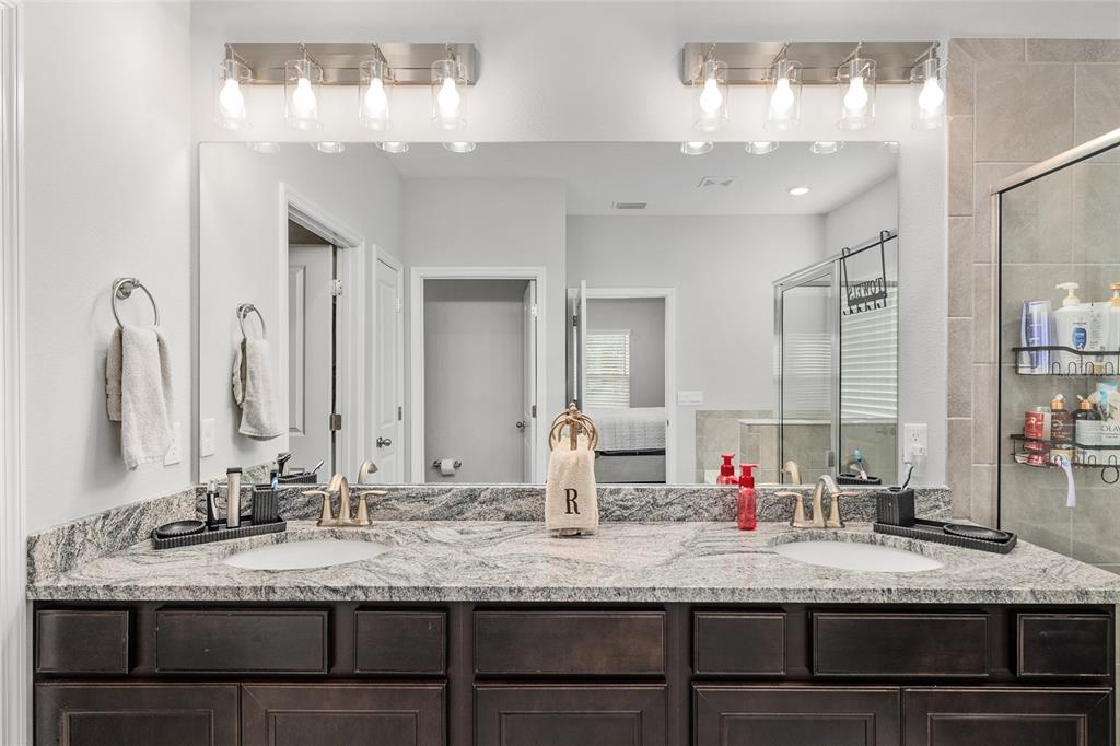 5912 Southwest 46th Drive Gainesville, FL 32608 - Photo 39 of 74 a bathroom with a granite countertop sink and a mirror
