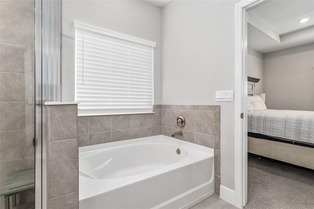 5912 Southwest 46th Drive Gainesville, FL 32608 - Photo 42 of 74 a bathroom with a tub and a window