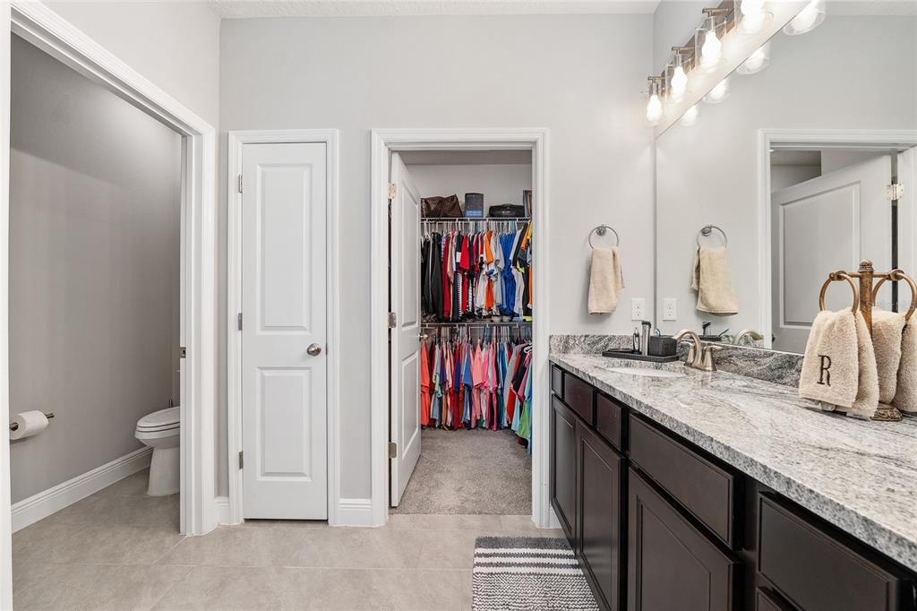 5912 Southwest 46th Drive Gainesville, FL 32608 - Photo 43 of 74 a bathroom with a double vanity sink and a mirror