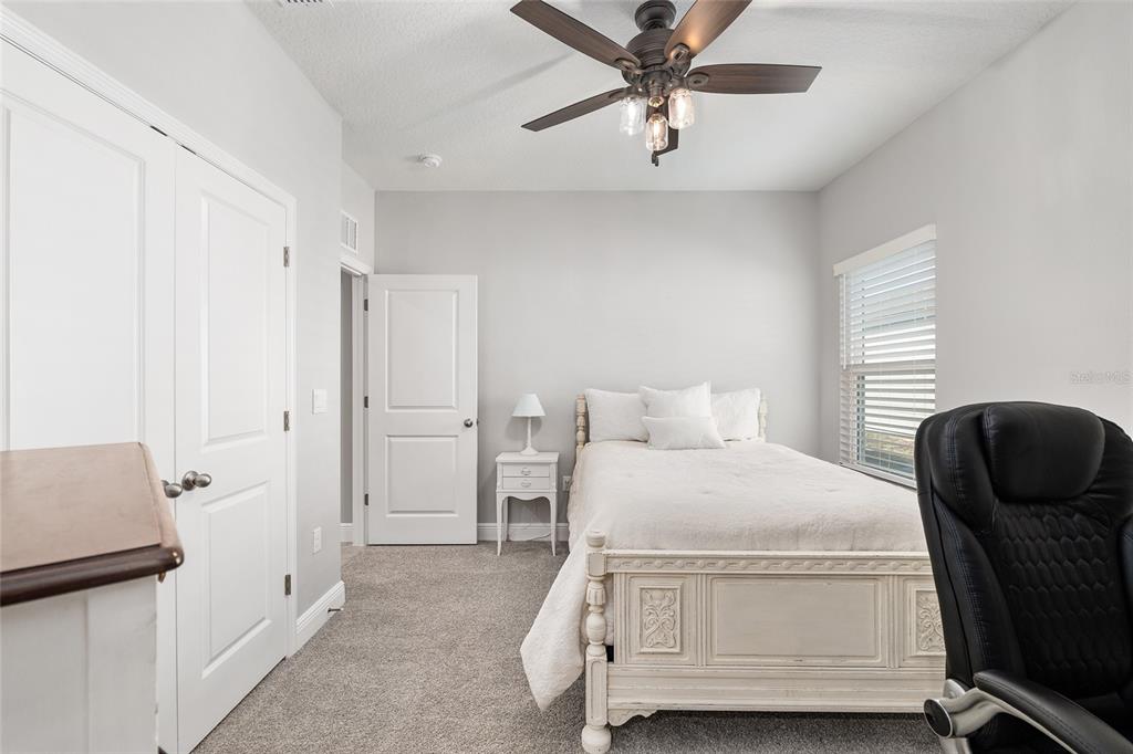 5912 Southwest 46th Drive Gainesville, FL 32608 - Photo 45 of 74 a bedroom with a bed and furniture