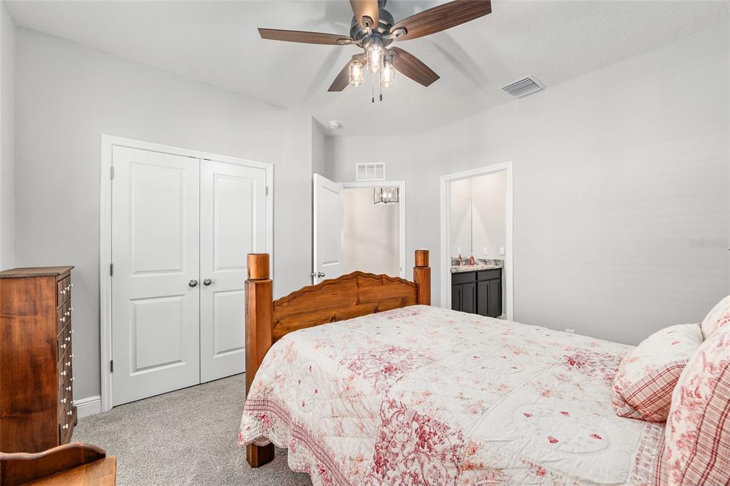 5912 Southwest 46th Drive Gainesville, FL 32608 - Photo 50 of 74 a bedroom with a bed and a flat tv screen