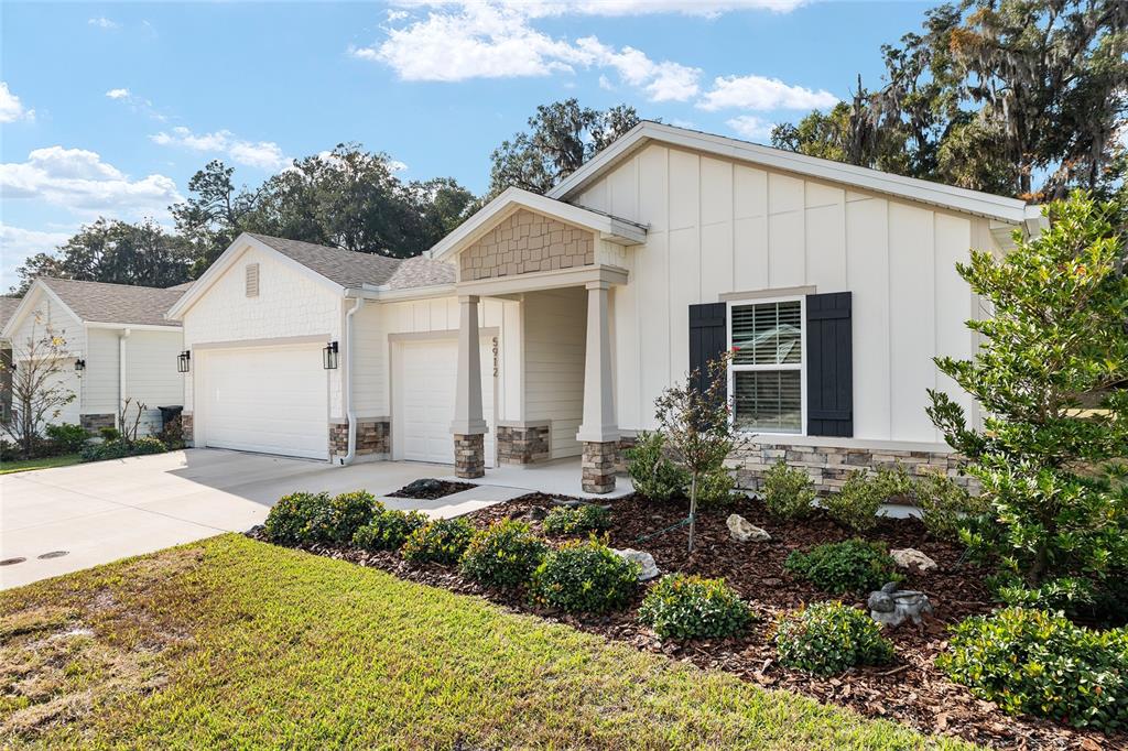 5912 Southwest 46th Drive Gainesville, FL 32608 - Photo 5 of 74 a front view of a house with a yard and garage