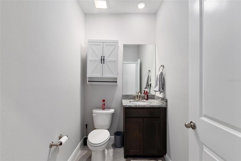 5912 Southwest 46th Drive Gainesville, FL 32608 - Photo 52 of 74 a bathroom with a sink toilet and a mirror
