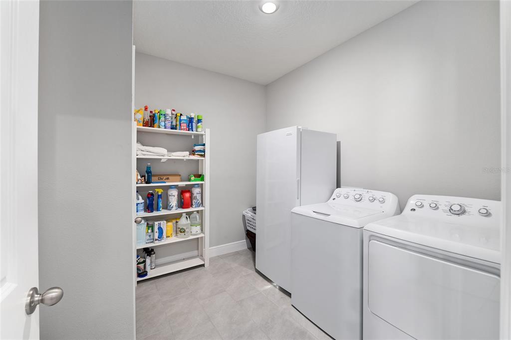 5912 Southwest 46th Drive Gainesville, FL 32608 - Photo 60 of 74 a utility room with dryer and washer
