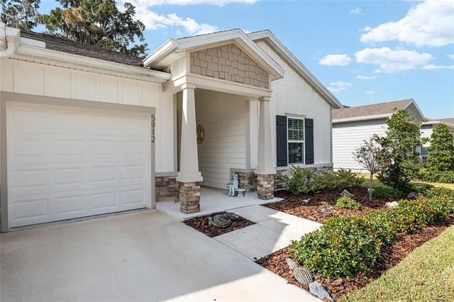 a view of a hallway with wooden floor and closet