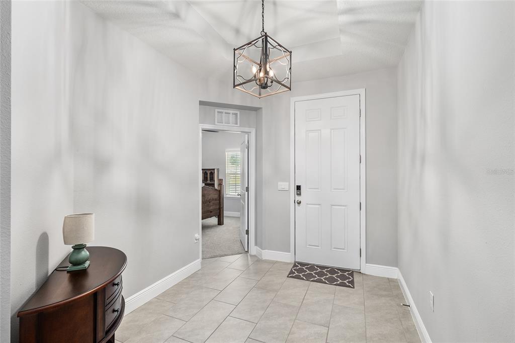 5912 Southwest 46th Drive Gainesville, FL 32608 - Photo 10 of 74 a view of a hallway with a chandelier