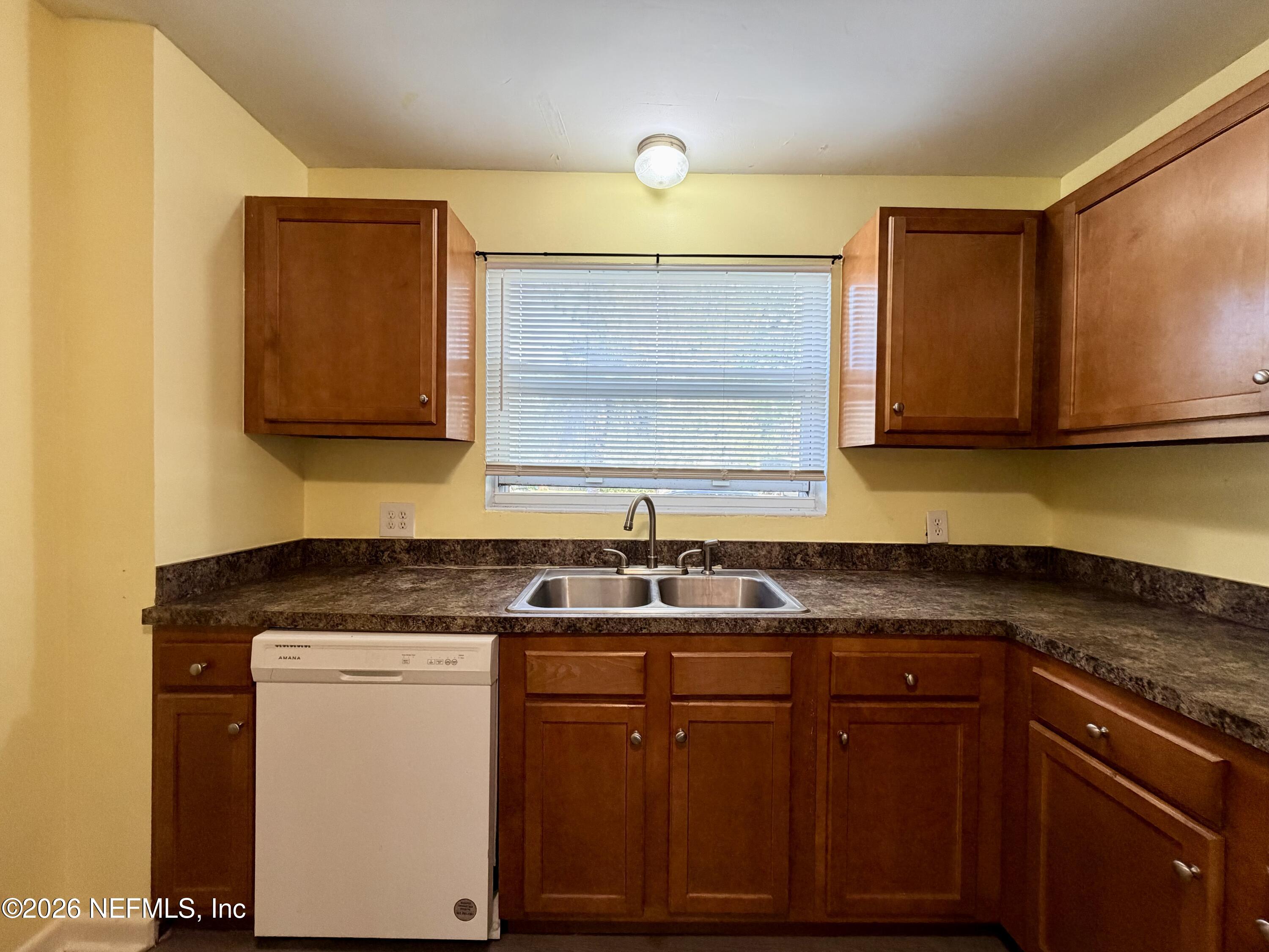 4037 Conga Street Jacksonville, FL 32217 - Photo 11 of 26 a kitchen with granite countertop a sink and cabinets
