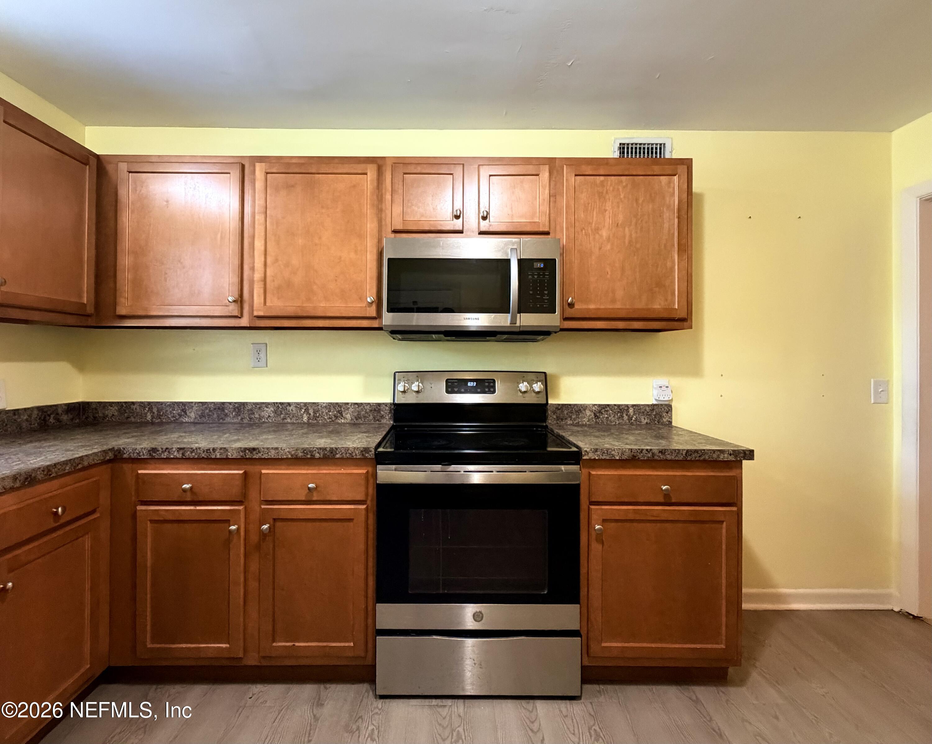 4037 Conga Street Jacksonville, FL 32217 - Photo 13 of 26 a kitchen with a stove and a microwave