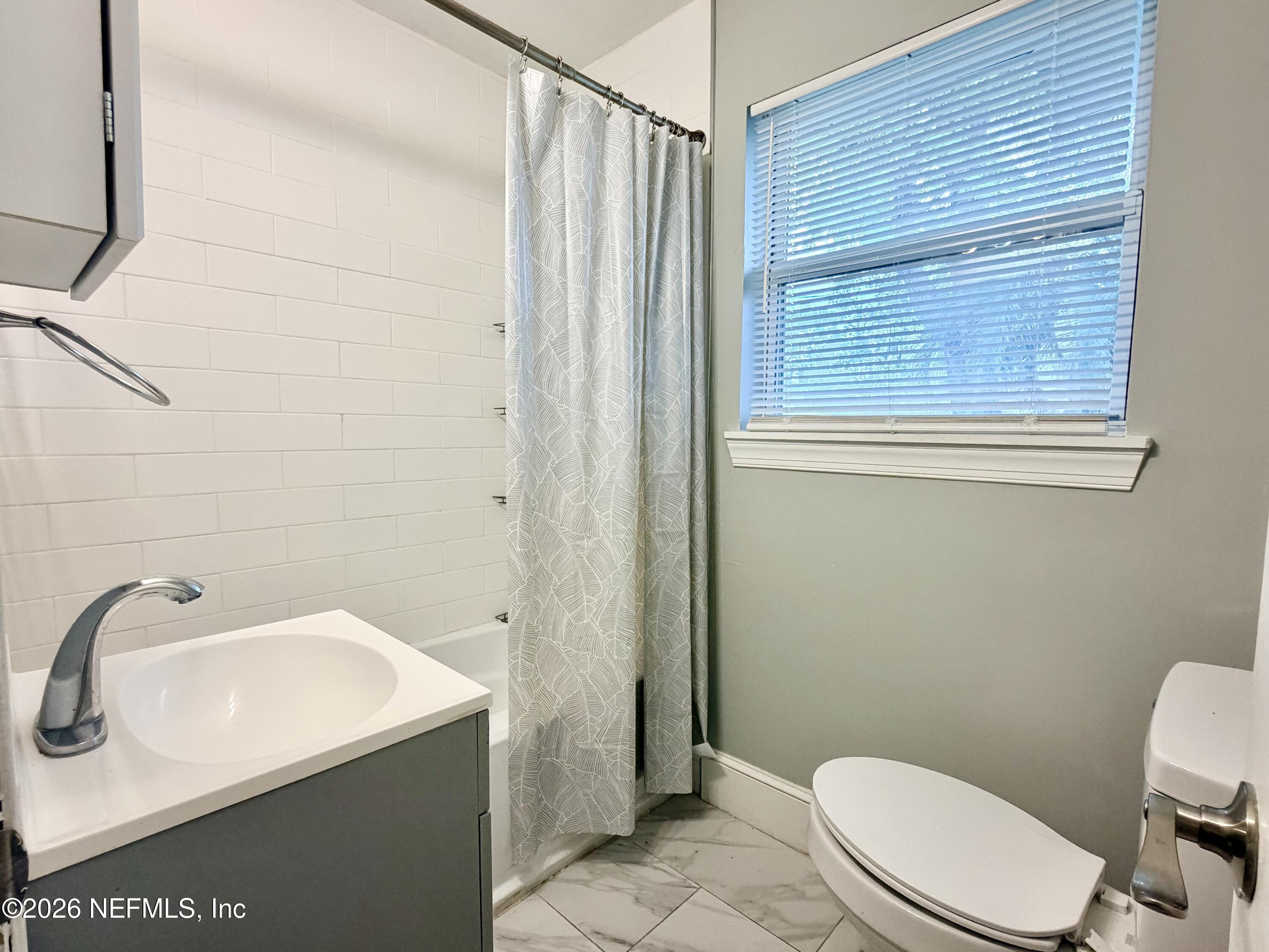 4037 Conga Street Jacksonville, FL 32217 - Photo 15 of 26 a bathroom with a sink a toilet and shower