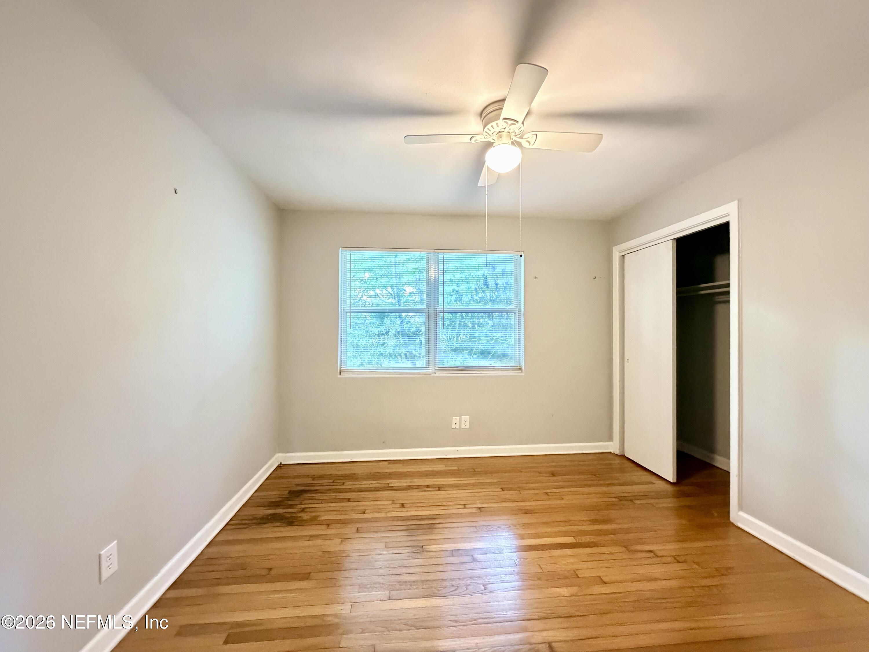 4037 Conga Street Jacksonville, FL 32217 - Photo 17 of 26 an empty room with wooden floor fan and windows