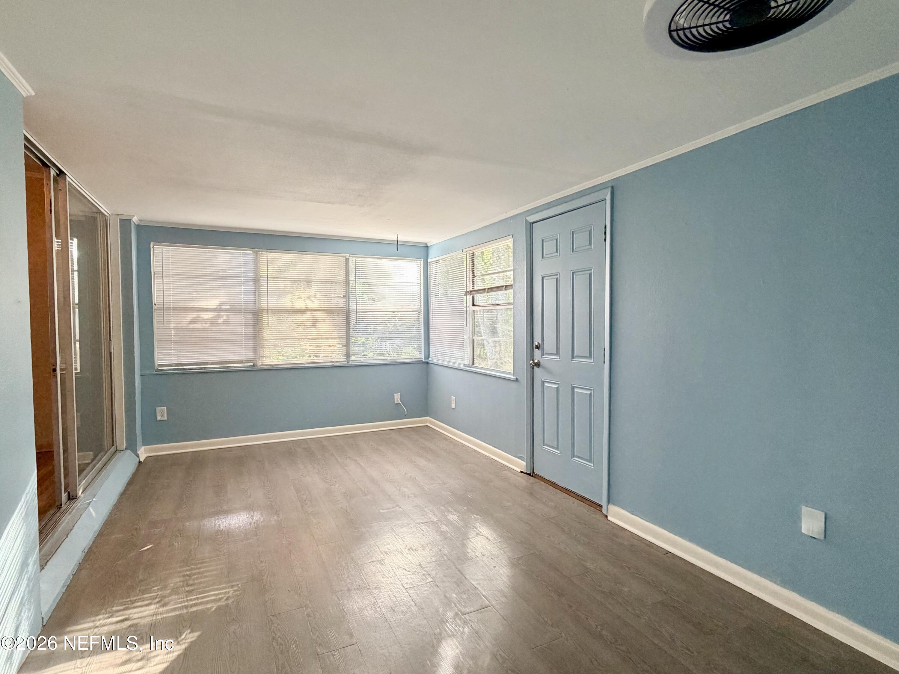 4037 Conga Street Jacksonville, FL 32217 - Photo 22 of 26 a view of an empty room with a window and a kitchen