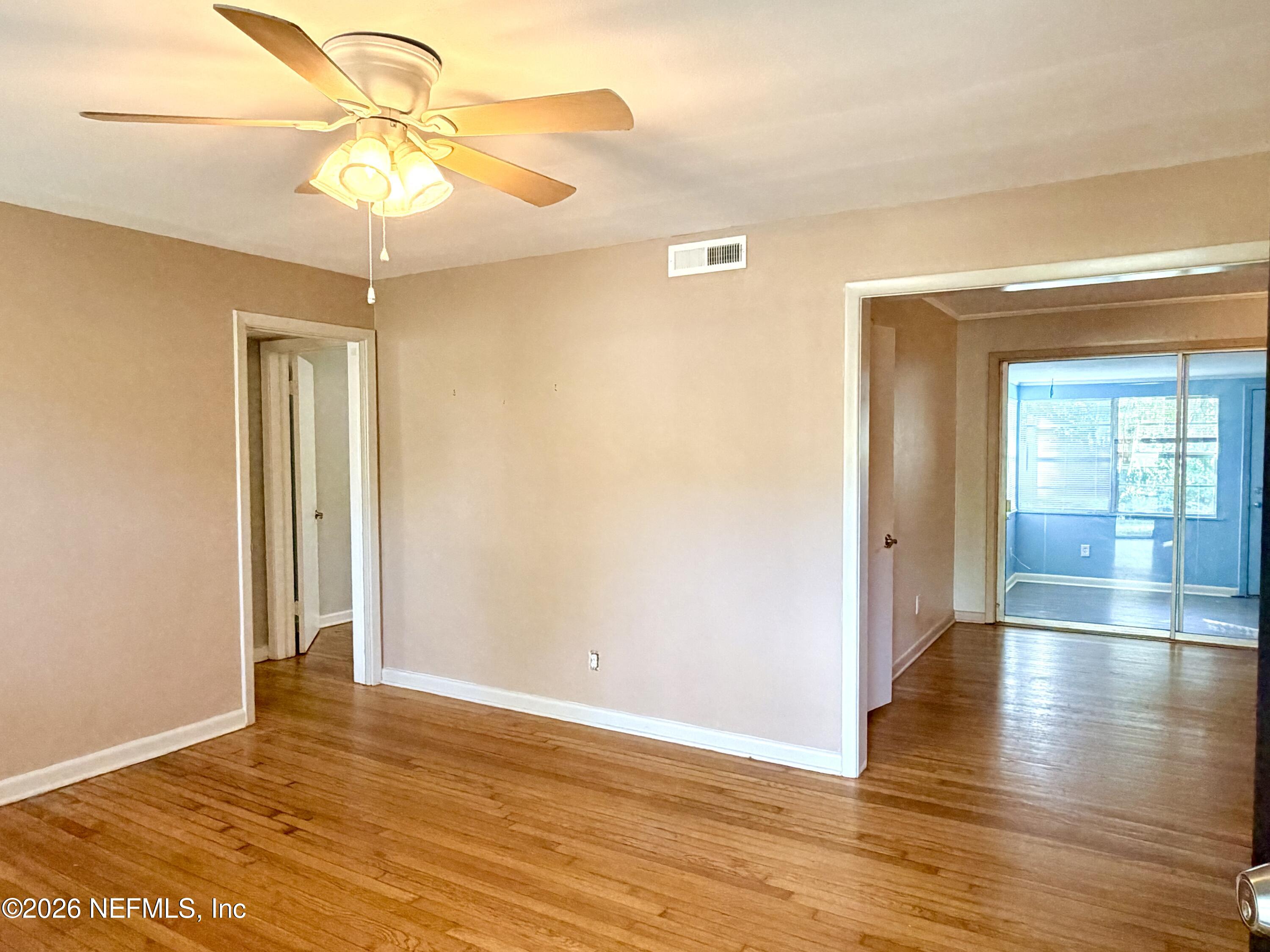4037 Conga Street Jacksonville, FL 32217 - Photo 4 of 26 a view of an empty room with window and wooden floor
